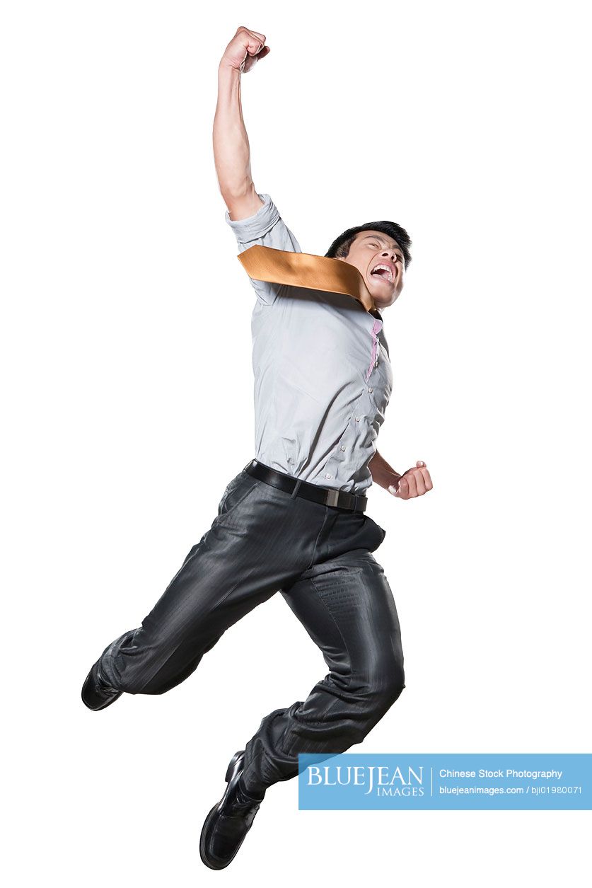 Chinese businessman in martial arts position mid-air