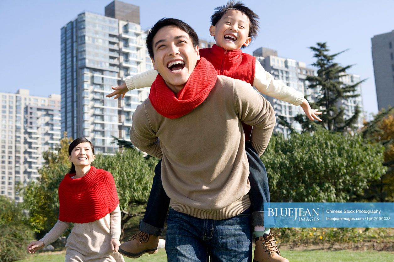 Young Chinese family enjoying a park in autumn