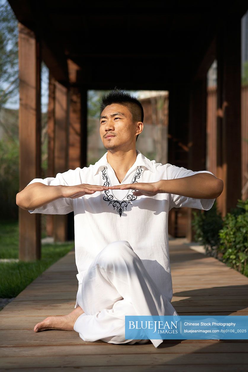 Chinese man meditating outdoors