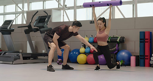 Young Chinese woman working out with personal trainer at gym,4K
