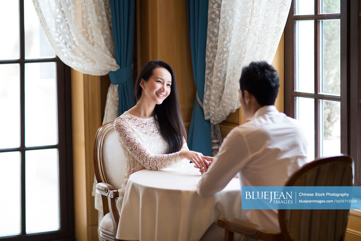 Young Chinese couple dating in restaurant