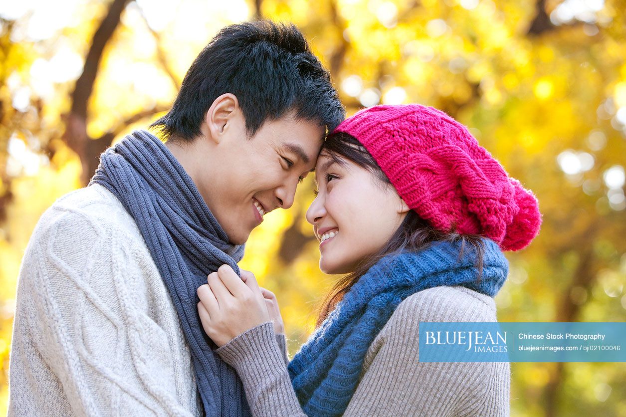 Young Chinese couple enjoying a park in autumn-High-res stock photo for