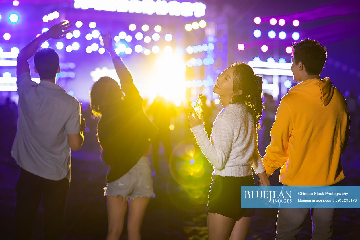 Happy young Chinese friends at music festival