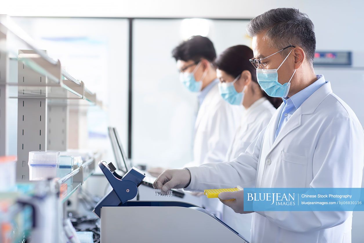 Chinese scientist examining medical samples in laboratory