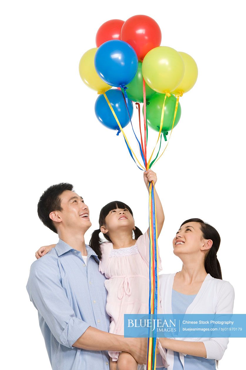 Portrait of Chinese family with balloons