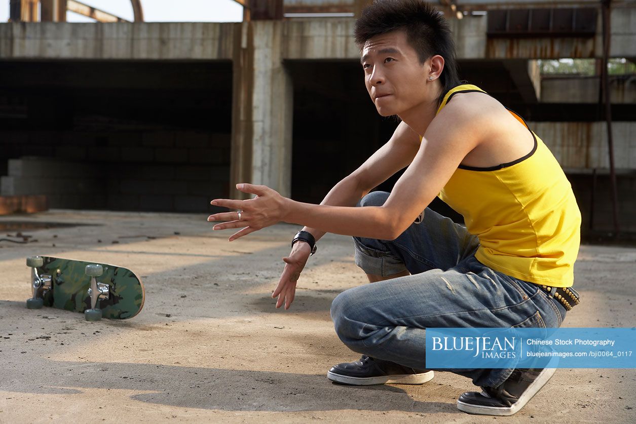 Chinese man crouching down