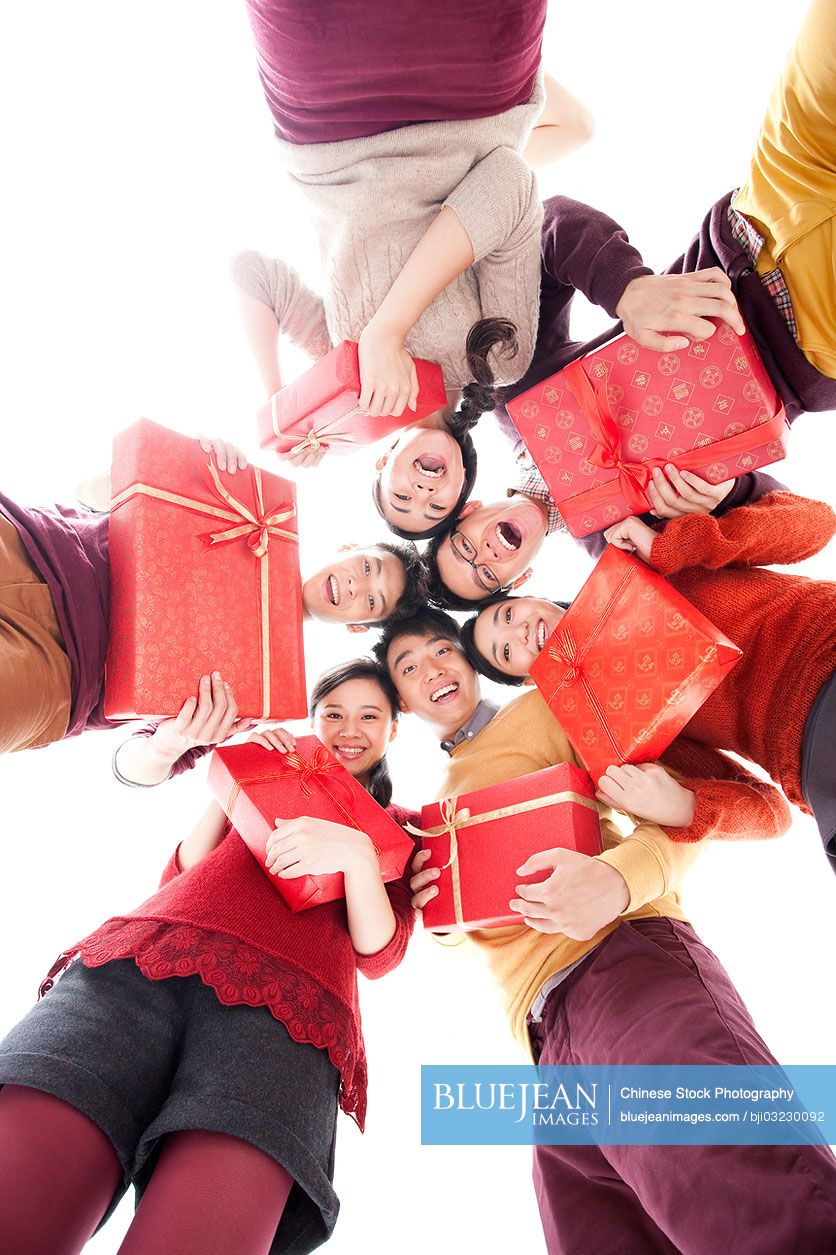 Happy young people with gifts in Chinese New Year