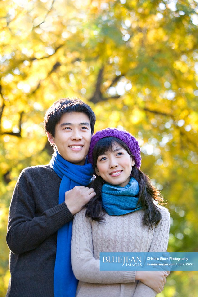 Young Chinese couple enjoying a park in autumn