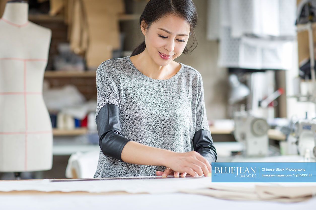 Chinese fashion designer working in studio