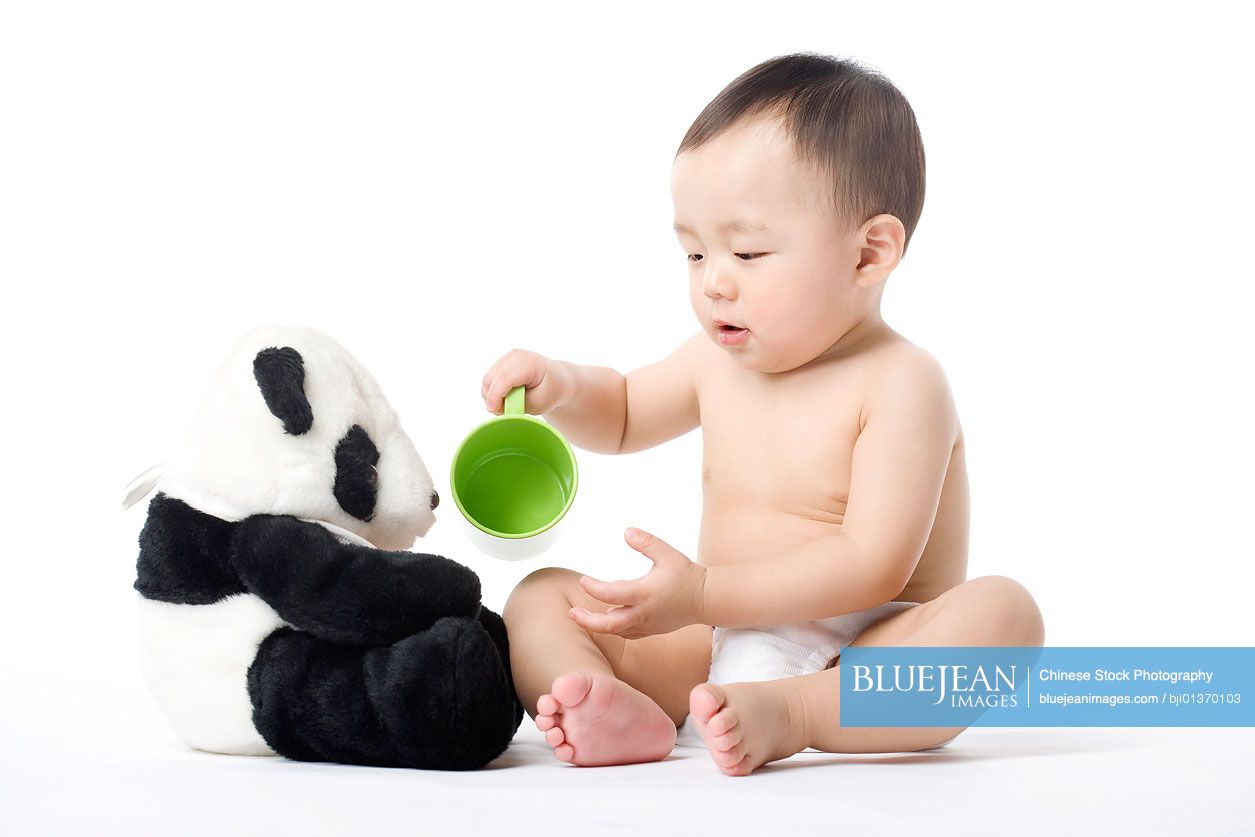 Chinese infant with panda and cup