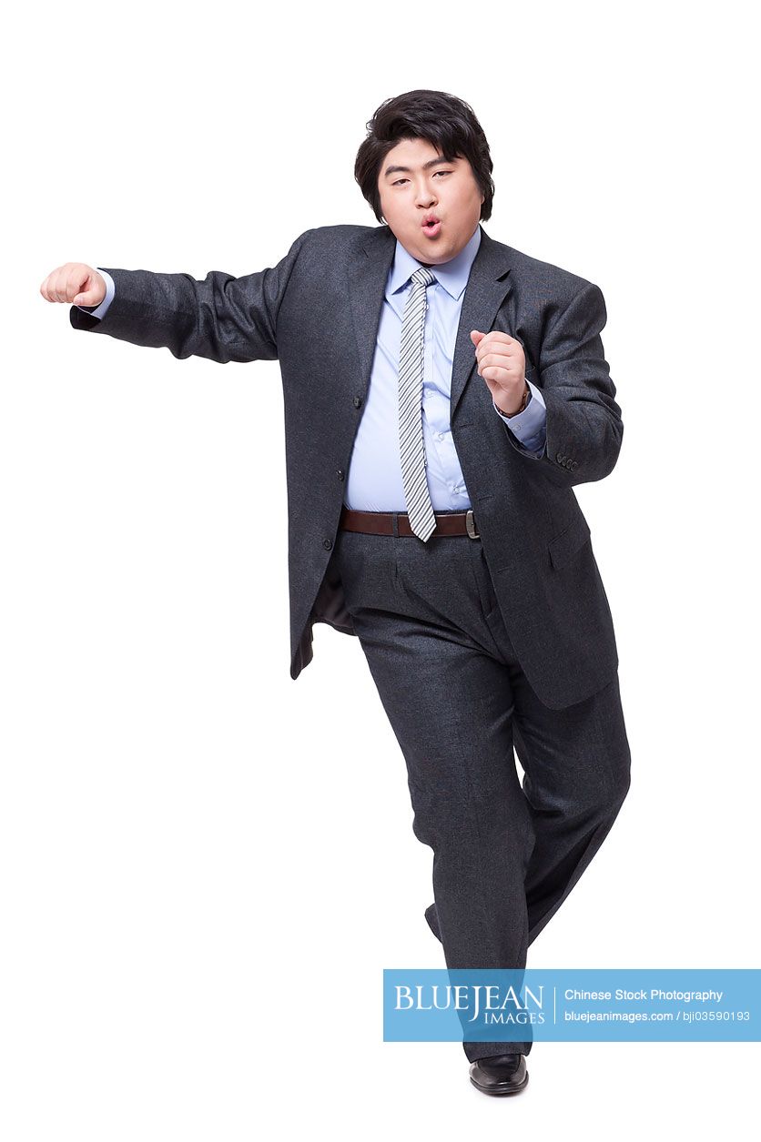 Happy overweight businessman dancing