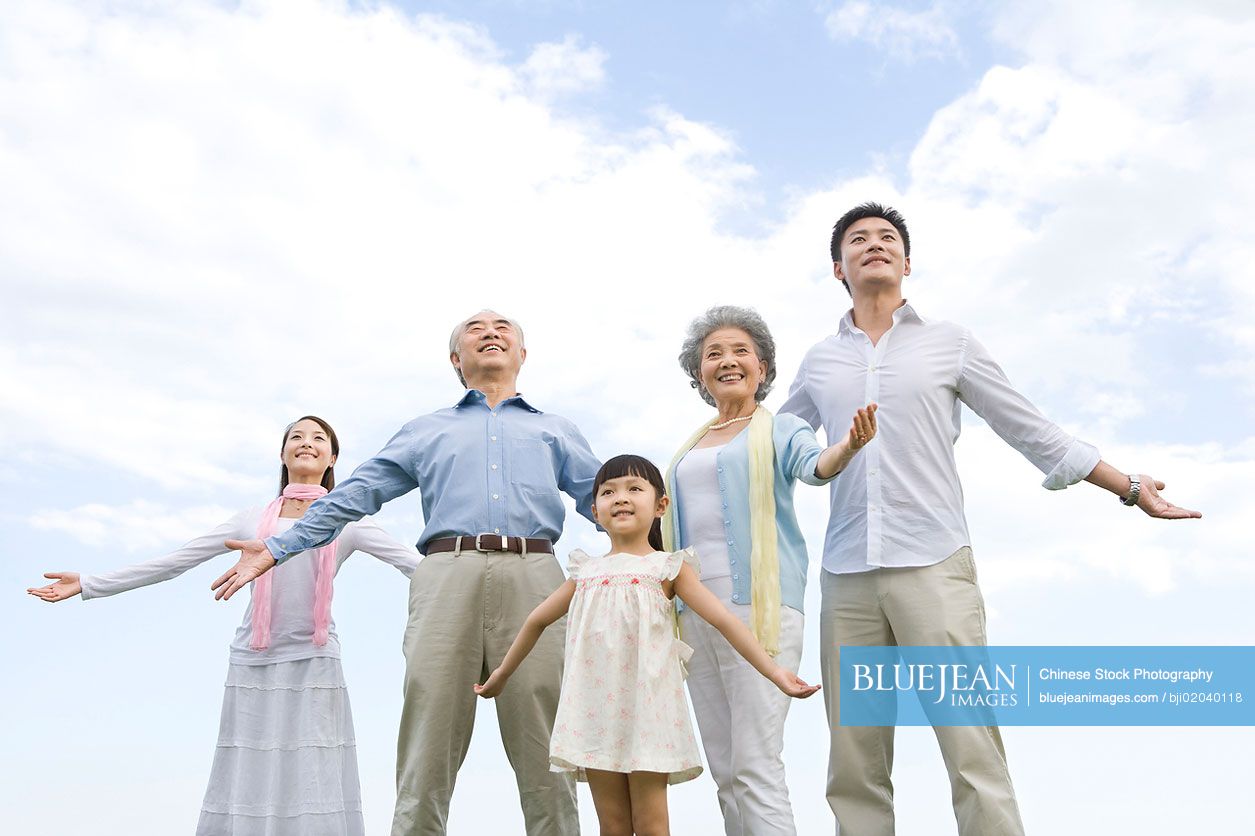 The whole Chinese family enjoying a beautiful day in the park