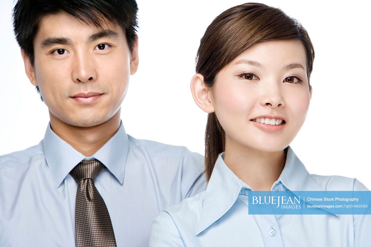 Portrait of young Chinese businessman and Chinese businesswoman, close-up