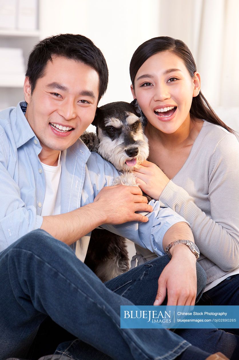Young Chinese couple with pet schnauzer