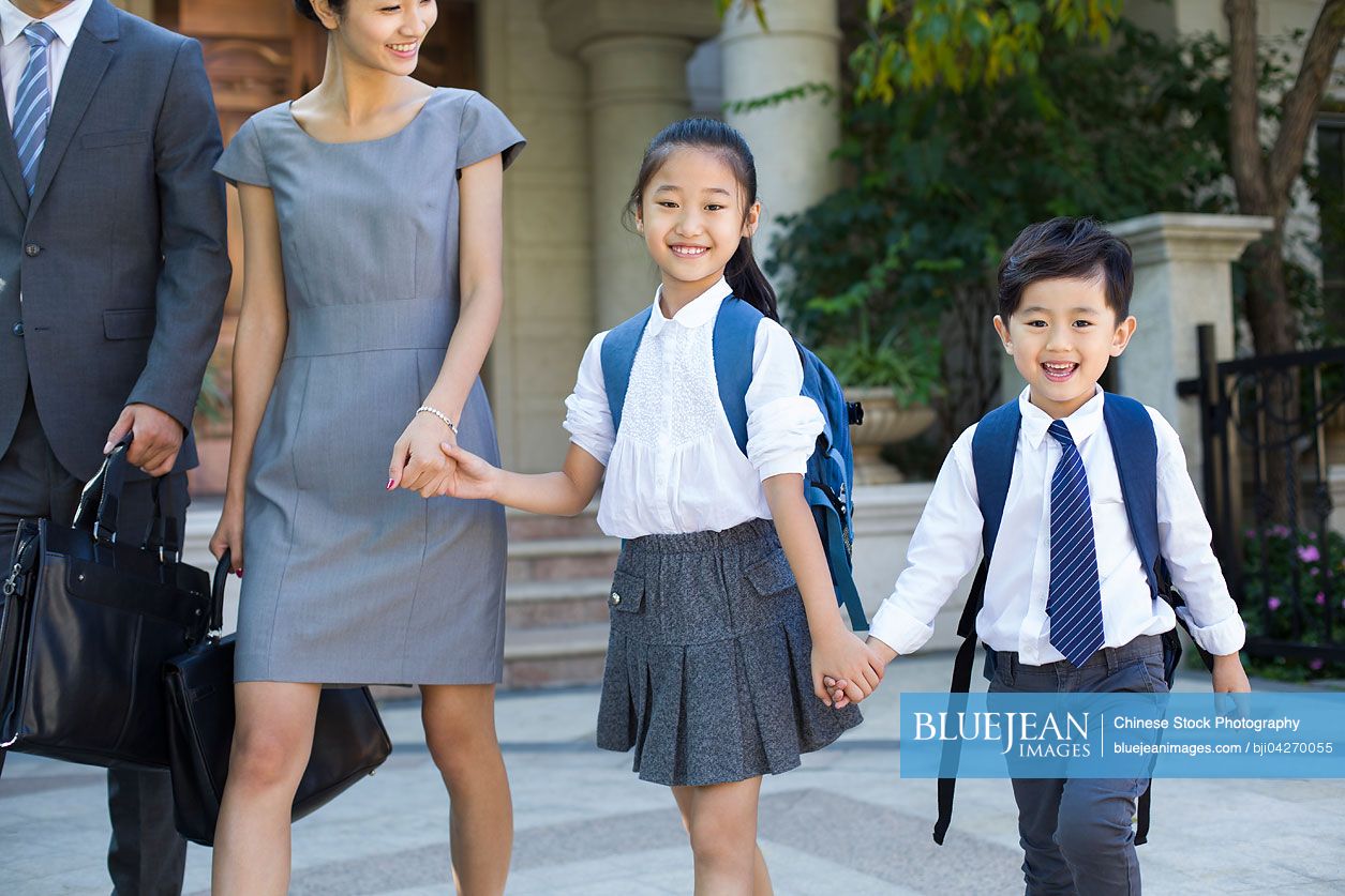 Young Chinese couple sending their children to school