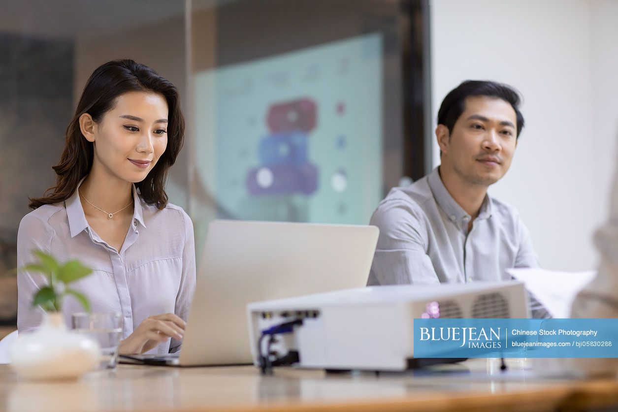 Chinese business people having meeting in board room 