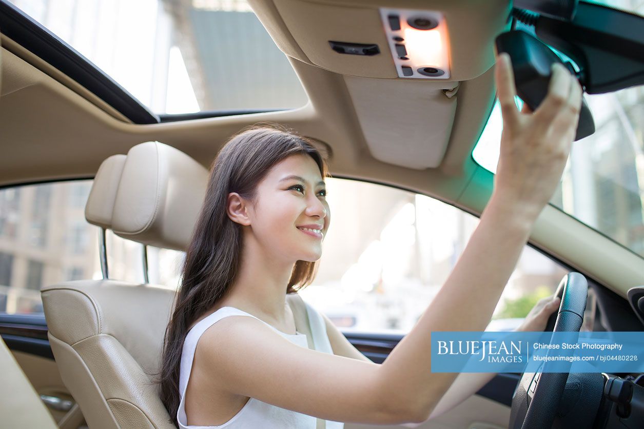 Young Chinese woman driving car