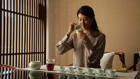 Happy young Chinese woman drinking tea,HD