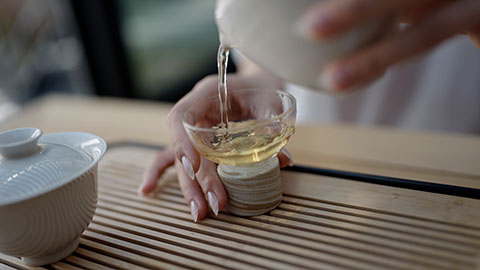 Elegant young Chinese woman drinking tea in tea room,4K