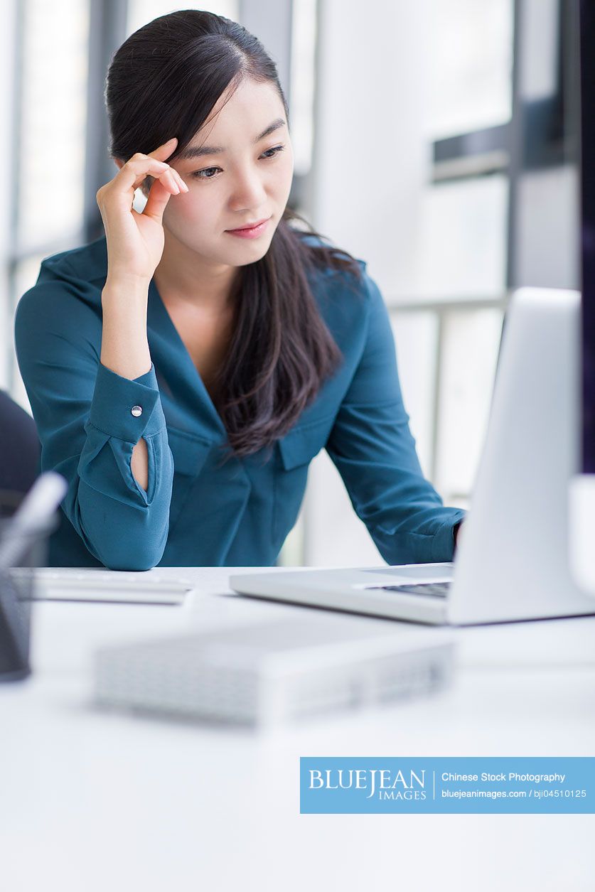 Young Chinese businesswoman working in office