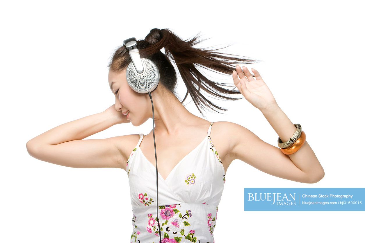 Young Chinese woman with headphones listening to music