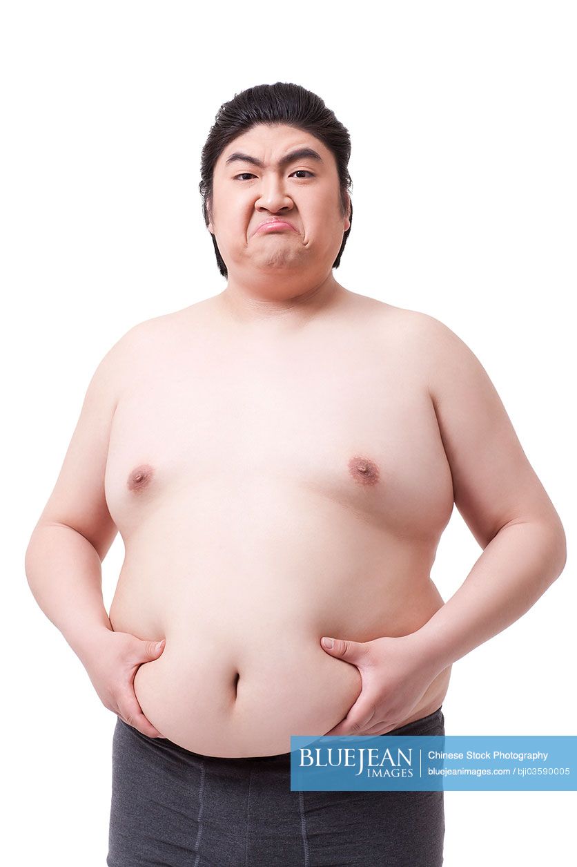 Funny obese Chinese man holding his pot belly-High-res stock photo for  download