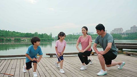 A young family works out in the park, staying active and healthy