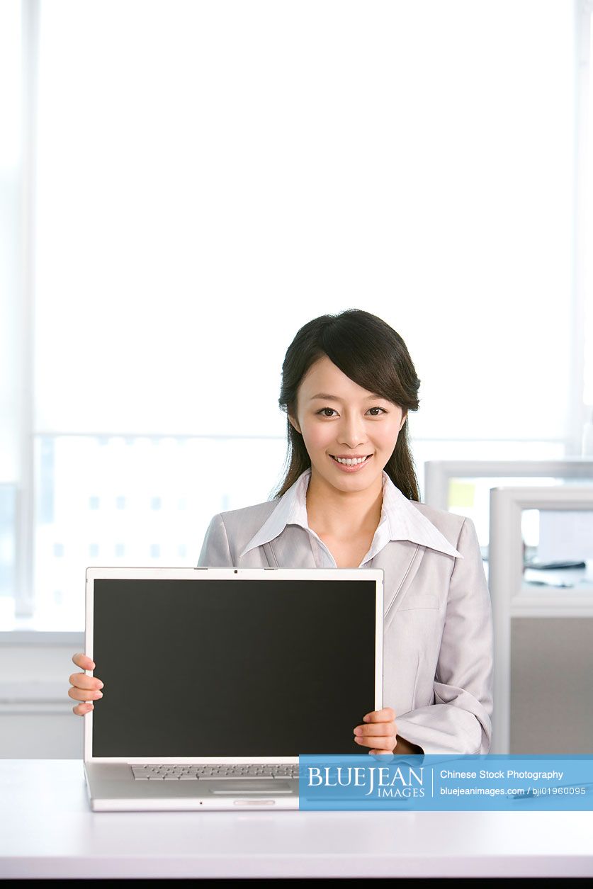 Chinese office worker at her desk