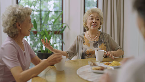 Happy senior Chinese friends having afternoon tea at home,4K