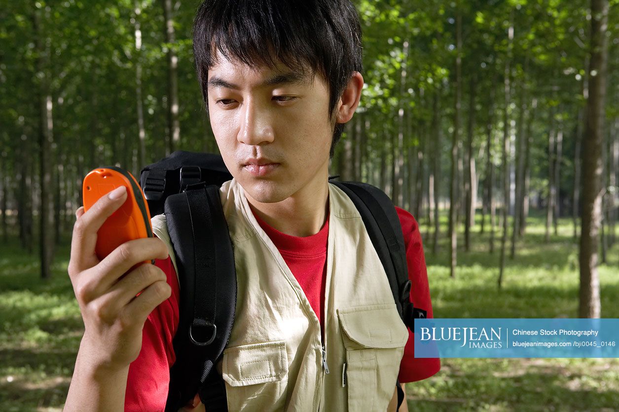 Chinese man looking at gps system high res stock photo for download