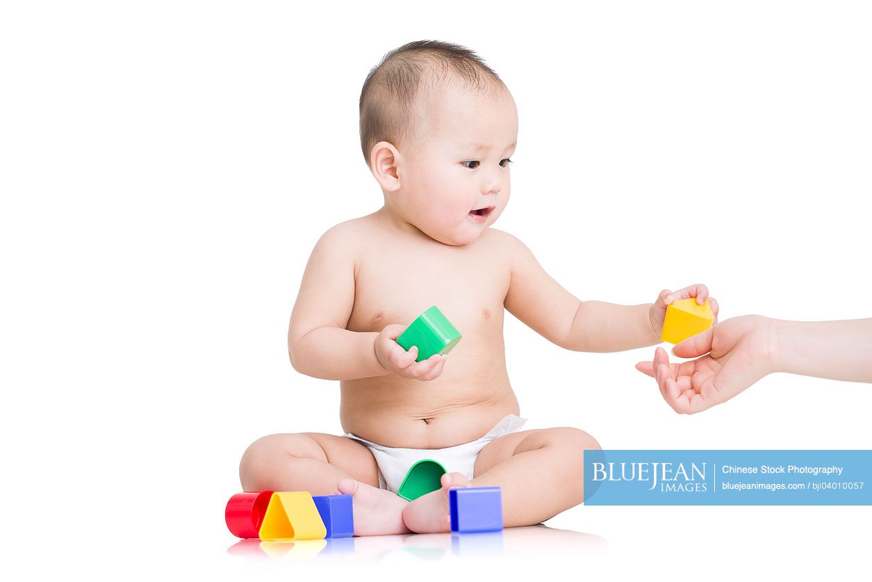 Cute Chinese baby boy playing building blocks