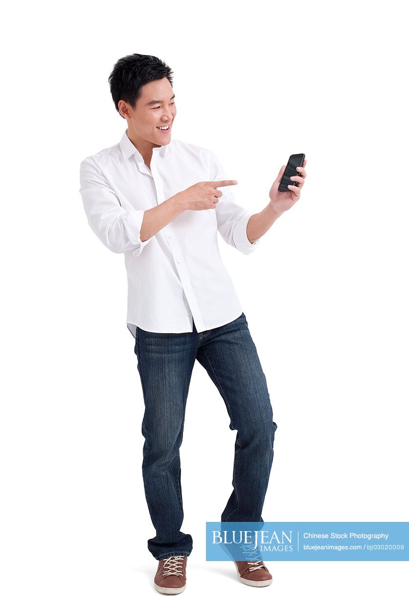 Young Chinese man showing mobile phone