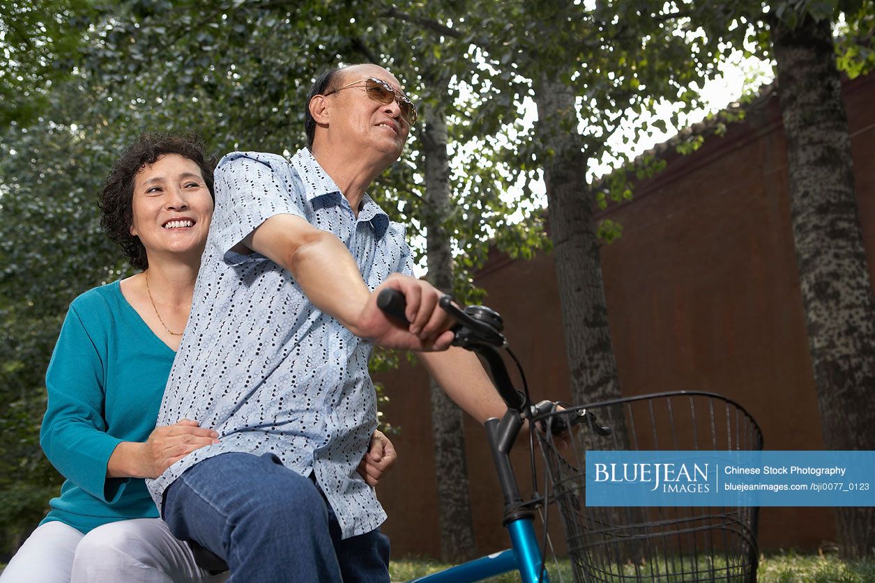 Portrait Of A Man And Chinese Woman On A Bicycle