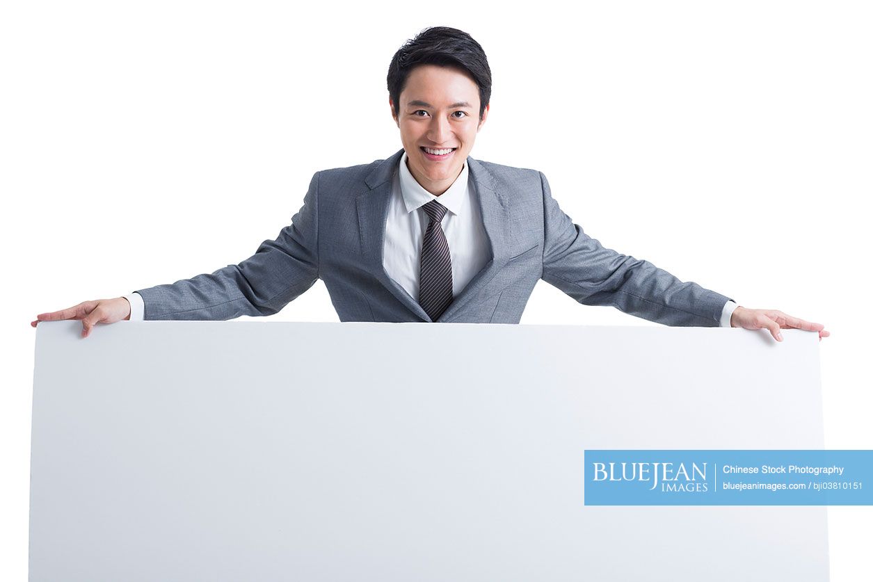 Young Chinese businessman with whiteboard