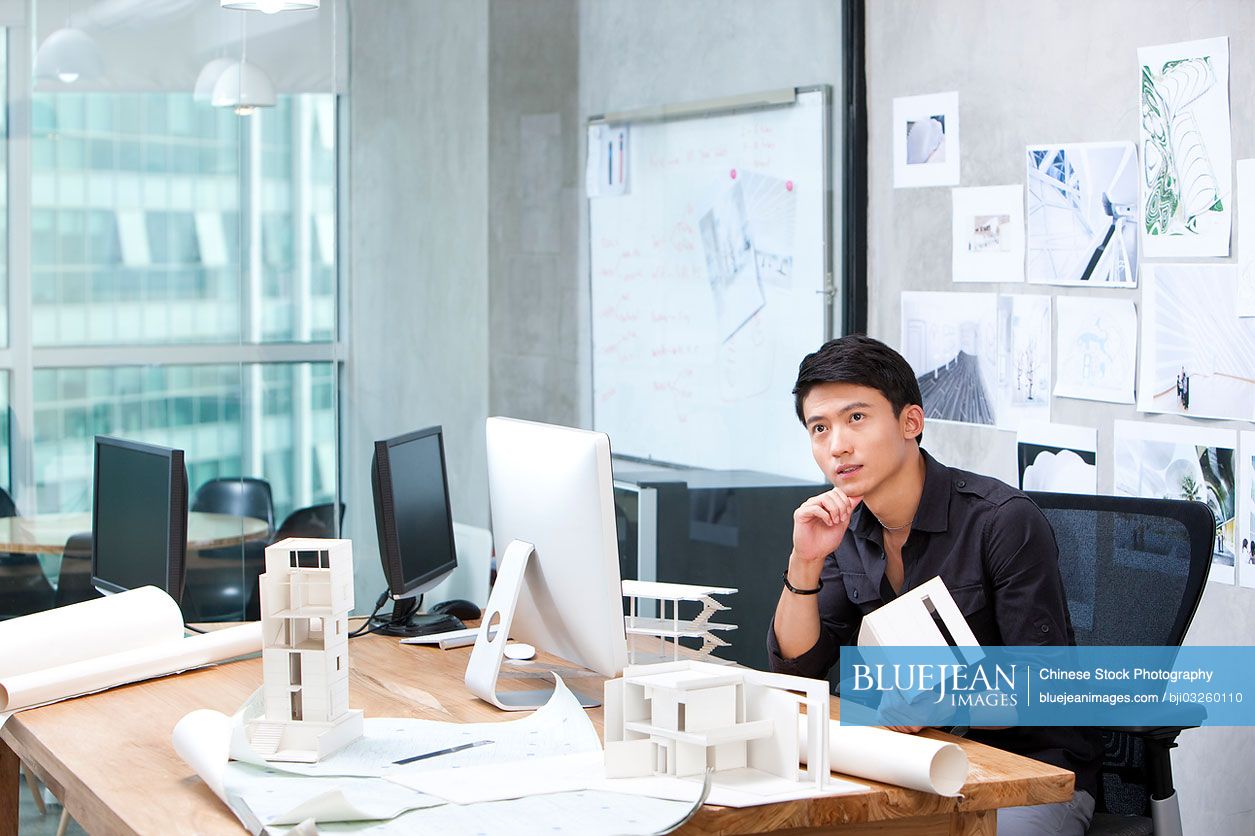 Chinese male architect working in studio