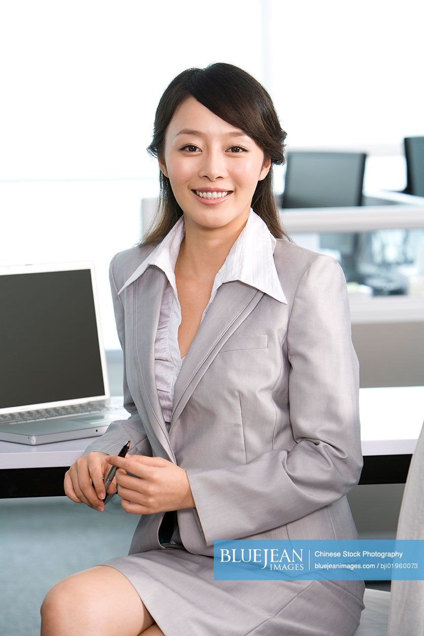 Chinese office worker at her desk