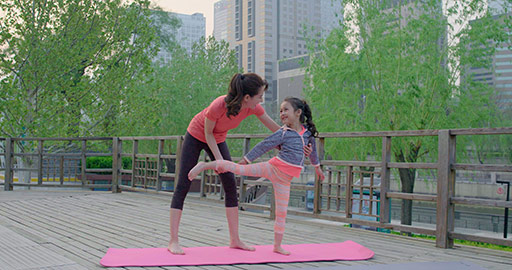 Happy Chinese mother and daughter doing yoga in park,4K