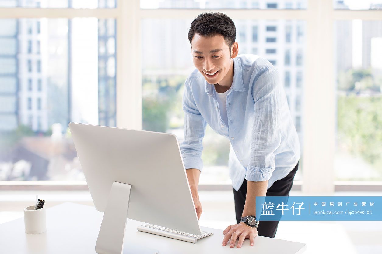 年轻商务男士在办公室使用电脑