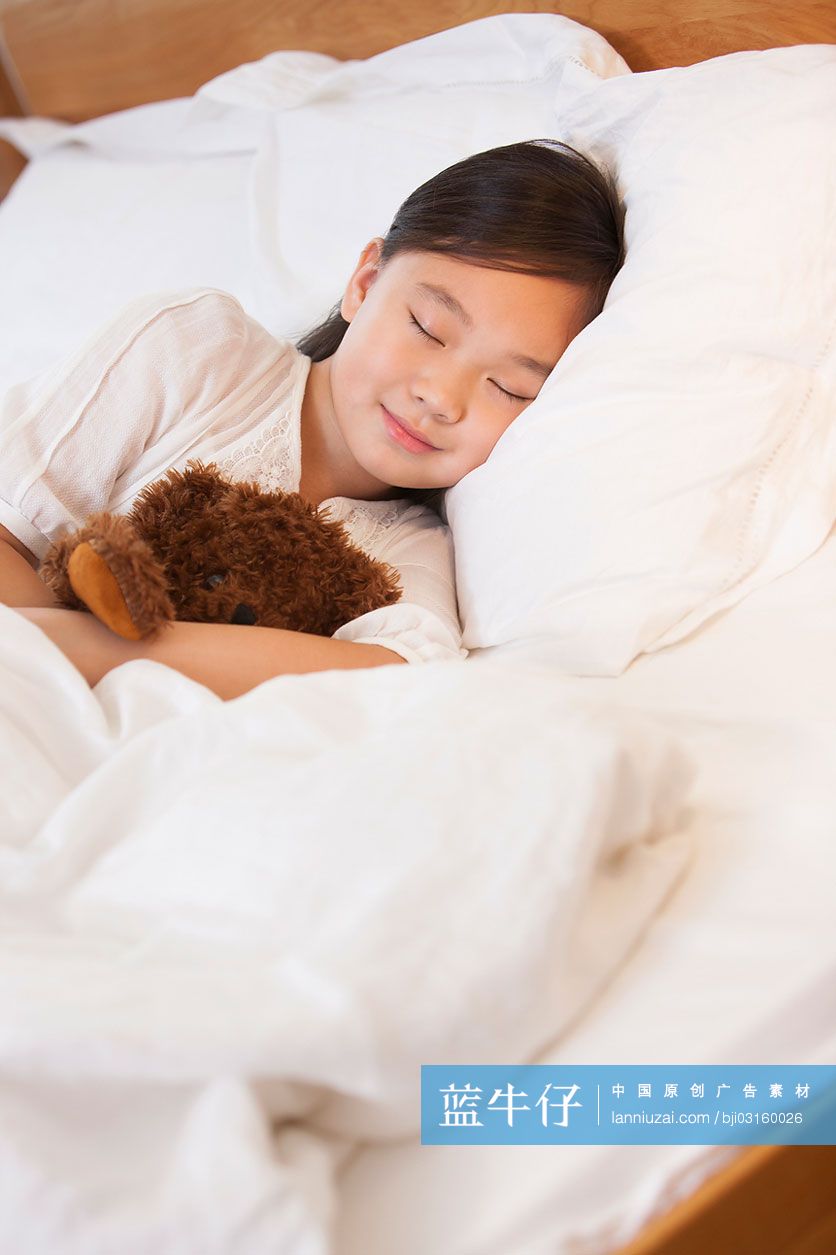 小女孩抱着泰迪熊睡觉