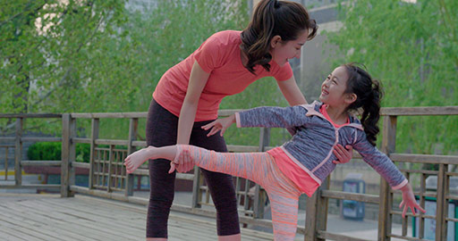 Happy Chinese mother and daughter doing yoga in park,4K