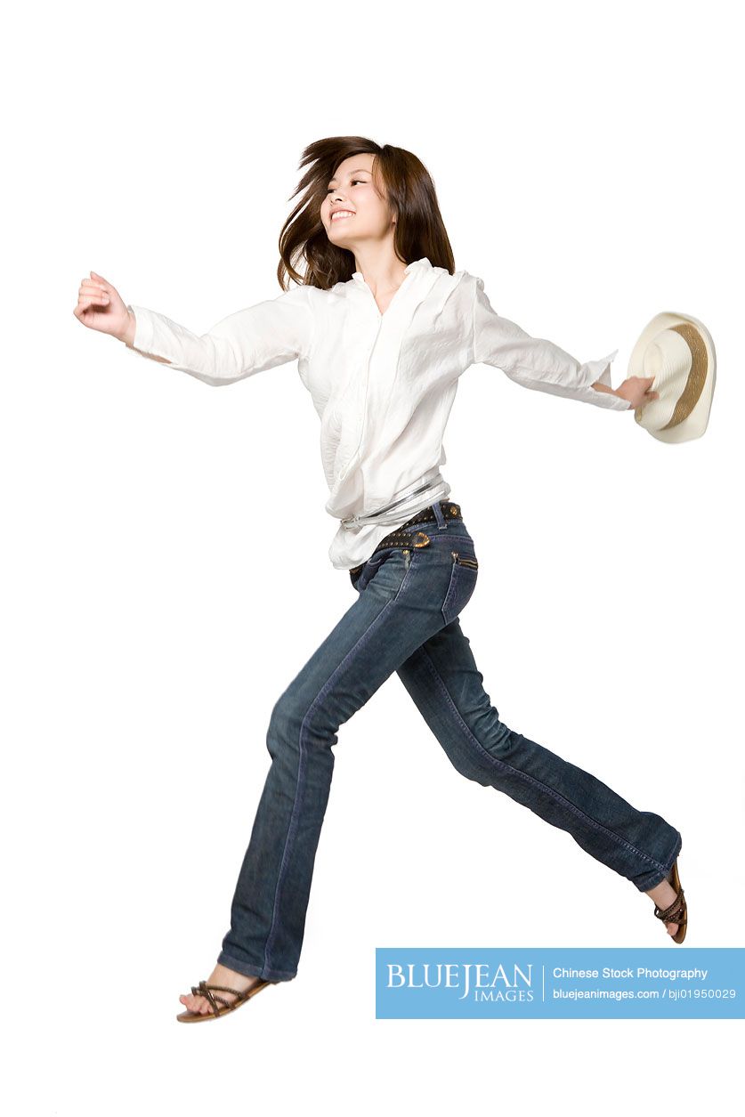 Portrait of young Chinese woman jumping