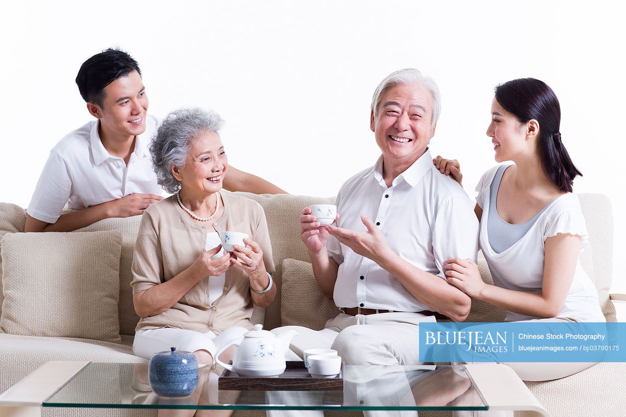 Happy Chinese family having tea and chatting