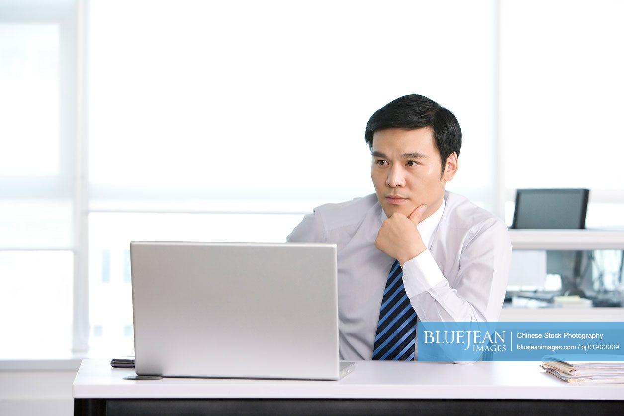 Chinese office worker at his desk