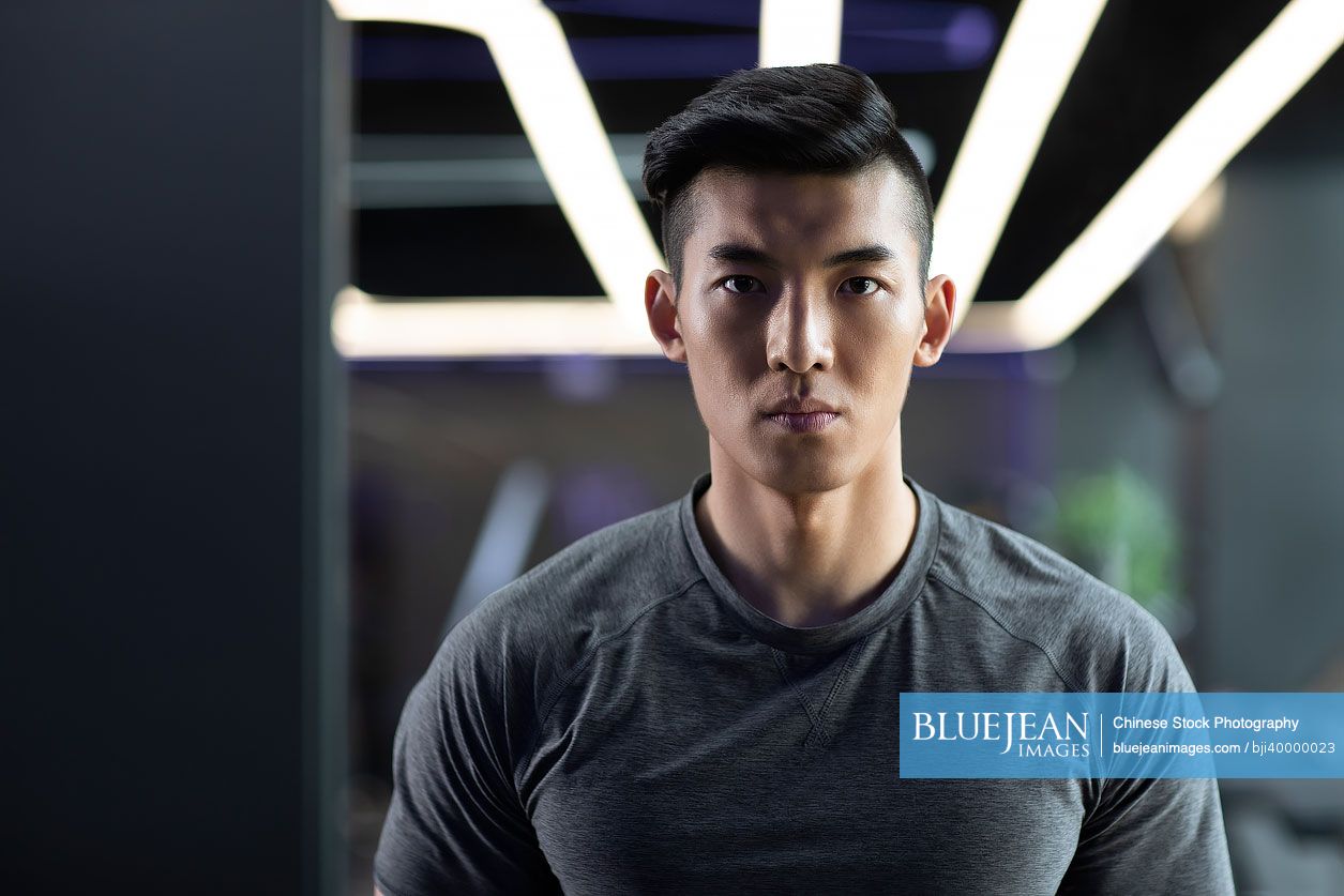 Young Chinese man exercising at gym