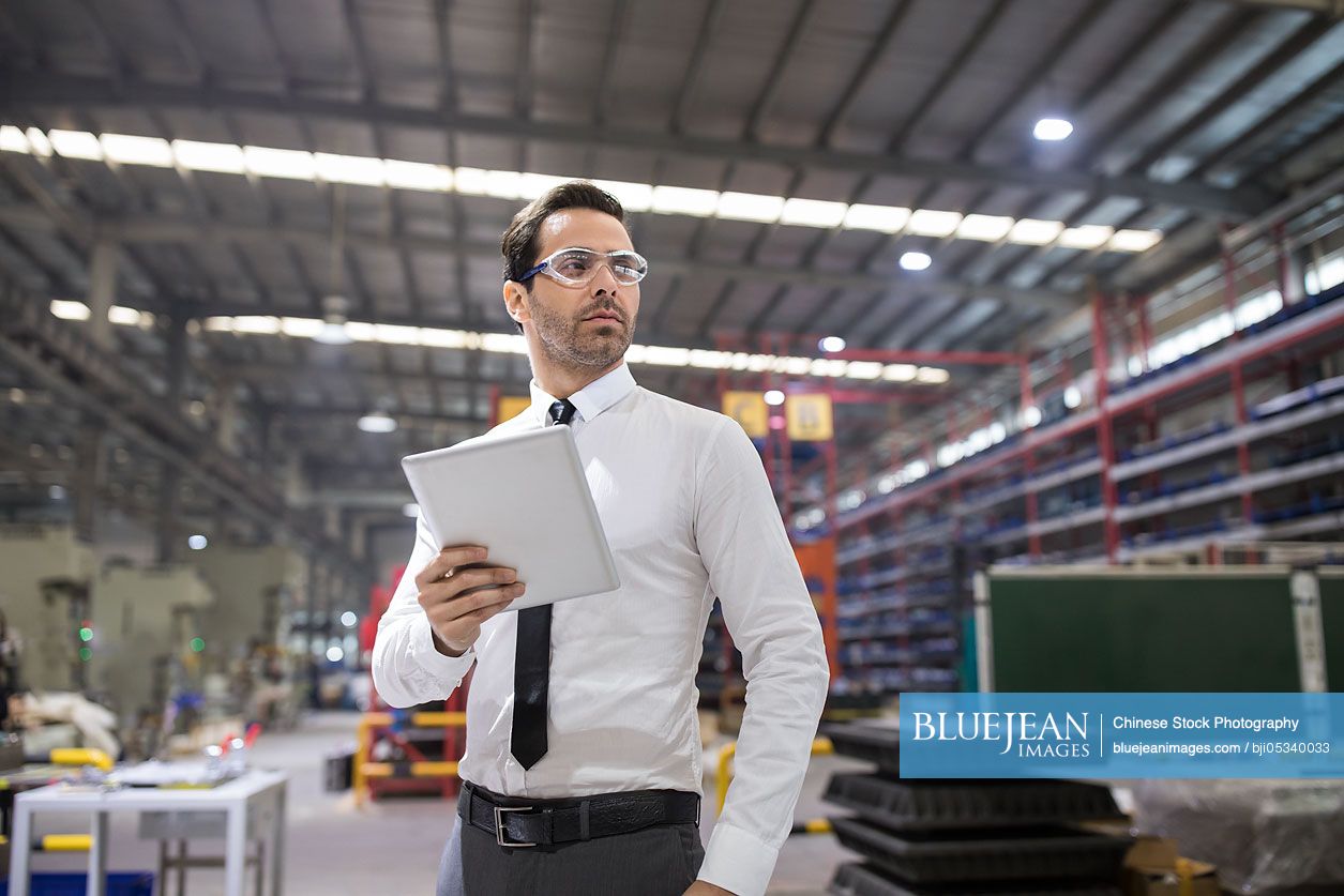 Businessman Holding A Digital Tablet In The Factory High Res Stock Photo For Download