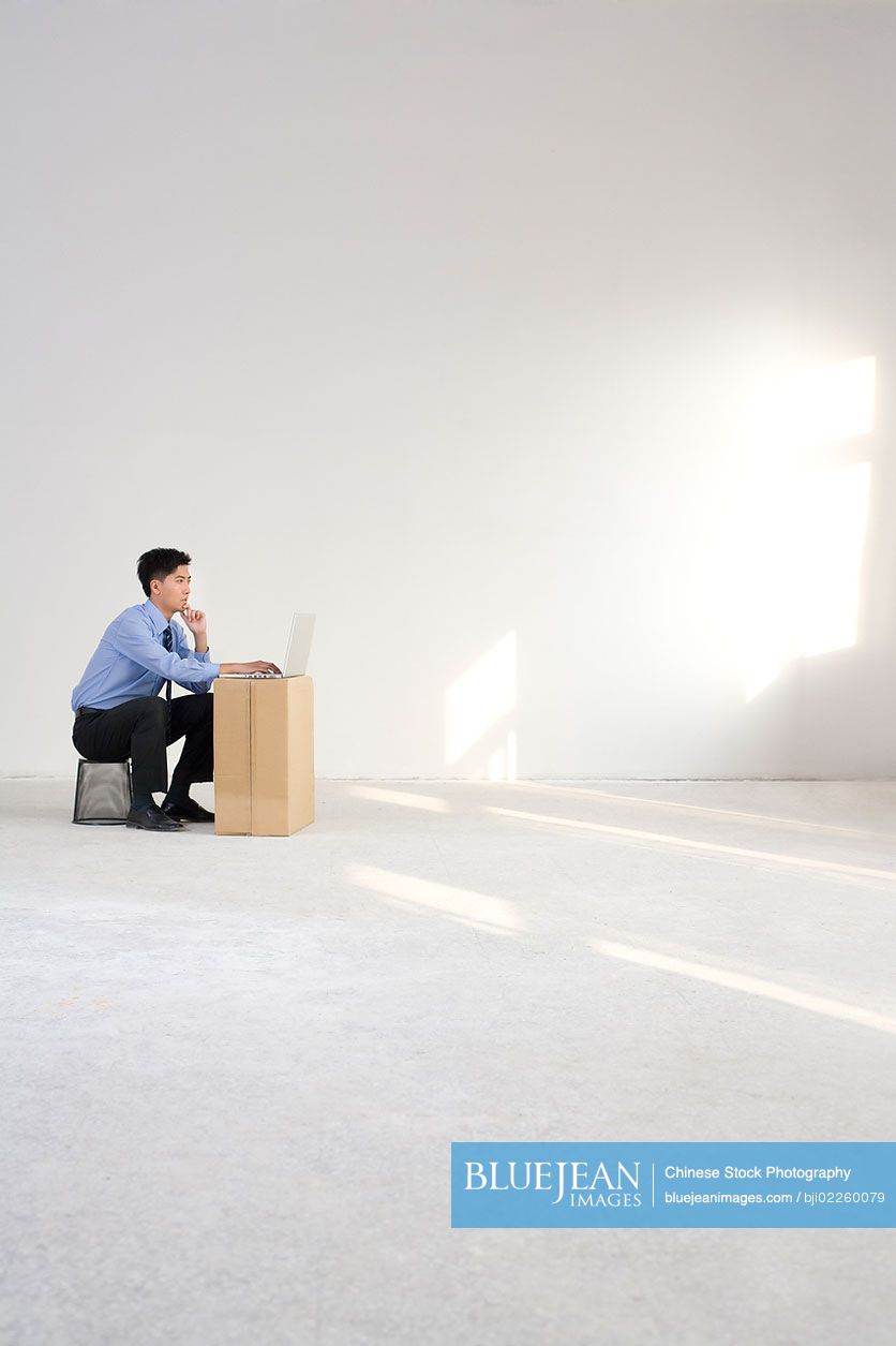 Chinese businessman working in an empty office space