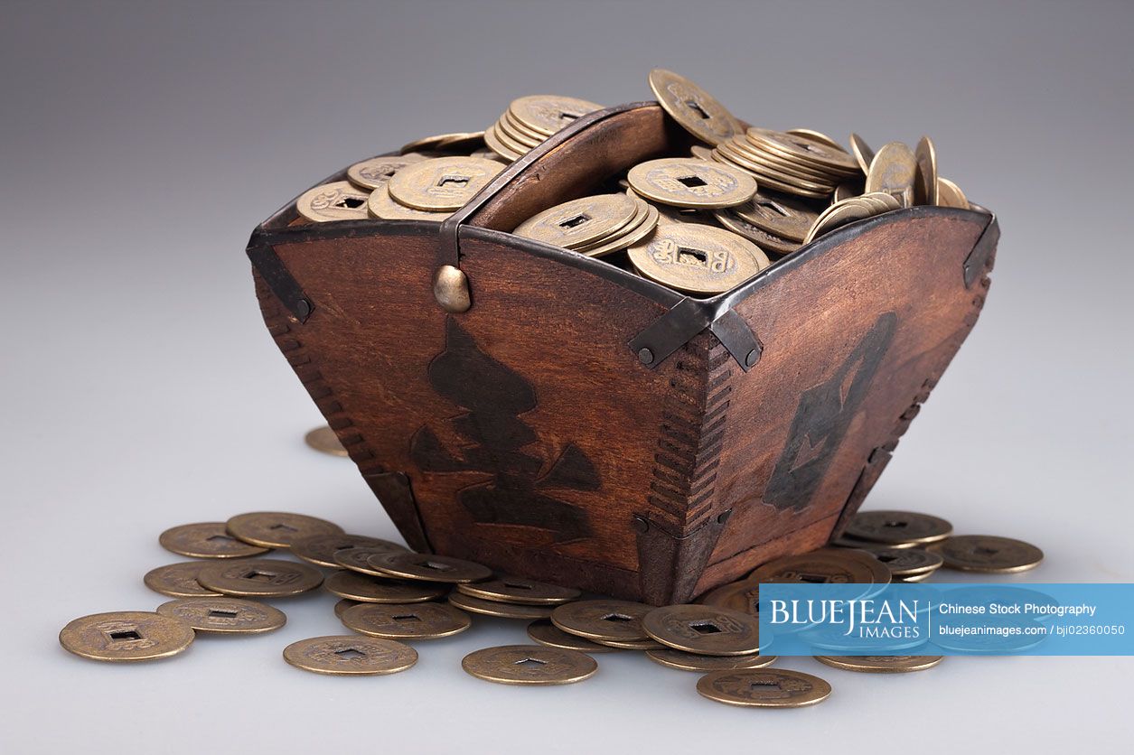 Wooden box full of ancient Chinese coins