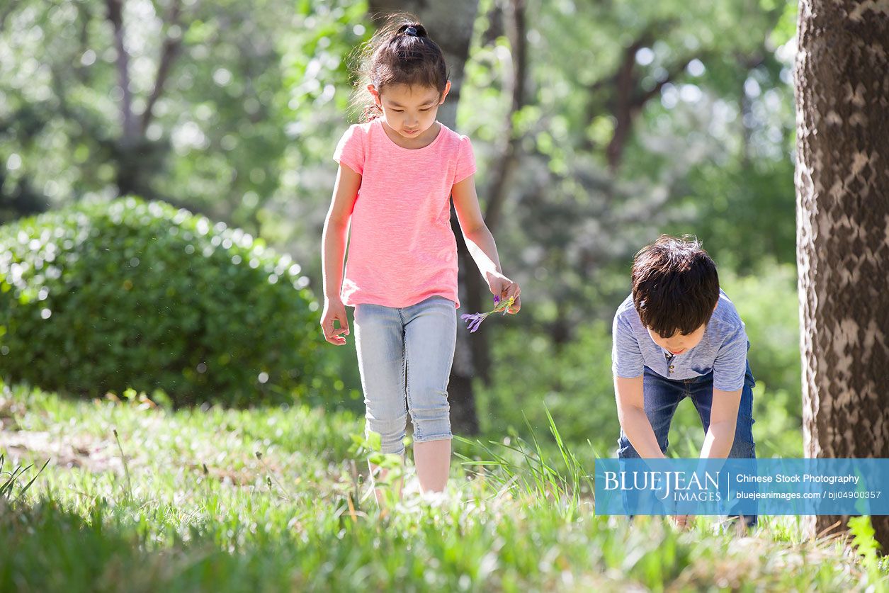 Happy Chinese children playing in woods