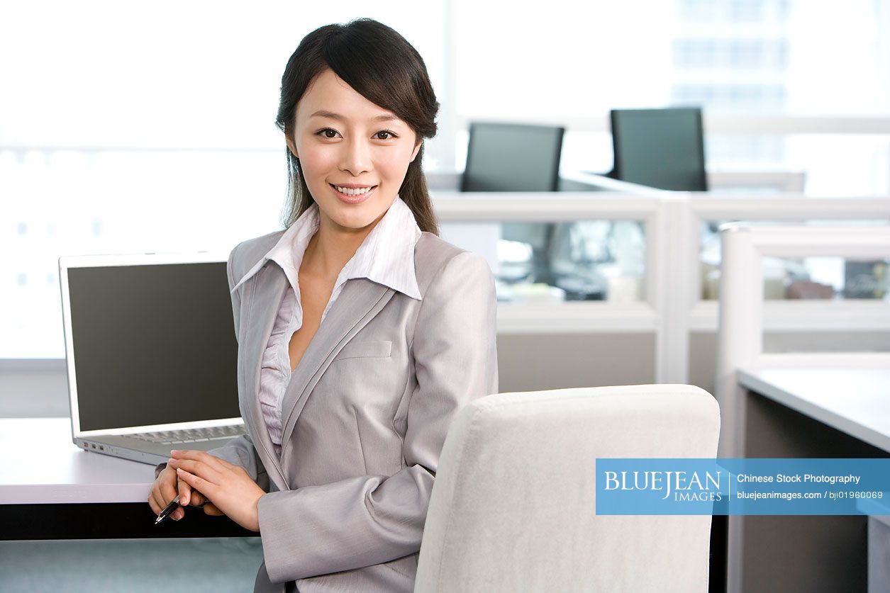 Chinese office worker at her desk