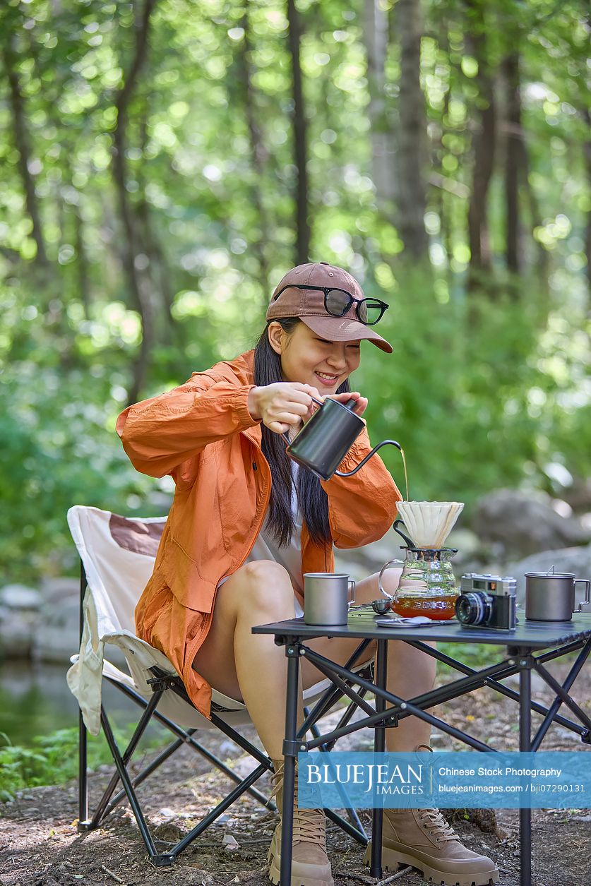 Happy woman sipping tea and enjoying the tranquil surroundings